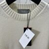 6931a059ccd8ab3d7af941e8 Dior 25SS New Arrival Knitwear from the DIOR AND KAWS Limited Edition Collection. Crafted from white and yellow wool knit fabric, one sleeve features the DIOR AND KAWS signature embroidery, reinterpreting the Dior logo with a colorful serpentine design. The hem and cuffs are finished with contrasting details, perfect for pairing with classic jeans or shorts to create a striking look.