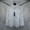 6931a062ccd8ab3d7af942aa Dior 24SS New Arrival Shirt Featured in Dior's Winter 2024 Men's Collection Show, Fashionably Tailored to Highlight Workwear Aesthetics, Crafted from Blue Striped Cotton Fabric with a Christian Dior Couture Embroidered Chest Pocket, Oversized Fit for a Casual Style