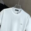 6931a0e9ccd8ab3d7af94c78 PRADA 2025 Spring/Summer New Arrival Round Neck Short Sleeve T-Shirt with Triangular Logo Patch on Chest and Side Stitch Pocket, Made of High Grammage 320g Double-Yarn Combed Cotton Fabric, Slightly Loose Fit, Soft and Substantial Fabric Texture, Unisex Design