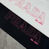 6931a103ccd8ab3d7af94e7f PRAD* Prada 25s New Arrival Unisex T-Shirt with Embroidered Back Logo, Contrast Pink Design, Triangle Metal Badge on Chest, 280g Pure Cotton Fabric, Classic Brand Lettering, High-Fashion Streetwear
