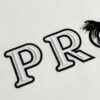 6931a116ccd8ab3d7af94fd8 Prada High-Version SS25 Spring/Summer Collection, In-Store Exclusive, Channel Luxury Item, Embroidered Logo Relief Series, Slightly Oversized Round-Neck Short-Sleeve T-Shirt