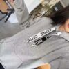 6931a19bccd8ab3d7af95a13 CELINE Letter Tape Drawstring Hoodie
