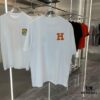 6931a28eccd8ab3d7af96a42 Hermes 2025 Spring-Summer New Short Sleeve T-Shirt with Hand-Customized Logo on Chest, Pure Cotton Fabric with Gold Thread Embroidery, Classic Buttoned Hem and OS Drop-Shoulder Fit