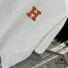 6931a28eccd8ab3d7af96a46 Hermes 2025 Spring-Summer New Short Sleeve T-Shirt with Hand-Customized Logo on Chest, Pure Cotton Fabric with Gold Thread Embroidery, Classic Buttoned Hem and OS Drop-Shoulder Fit