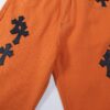 6931a3c9ccd8ab3d7af98066 Chrome Hearts & Croc Heart Art Basel Orange Flared Jeans with Cross Design