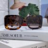 CHANEL New Classic Black and White Sunglasses with Logo-Embellished Temples