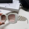 6931f82b3a89a121ed5497a5 CHANEL New Classic Black and White Sunglasses with Logo-Embellished Temples