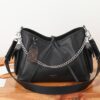 Louis Vuitton This small CarryAll Cargo handbag is crafted from soft lambskin, featuring a stylishly micro-crinkled finish.