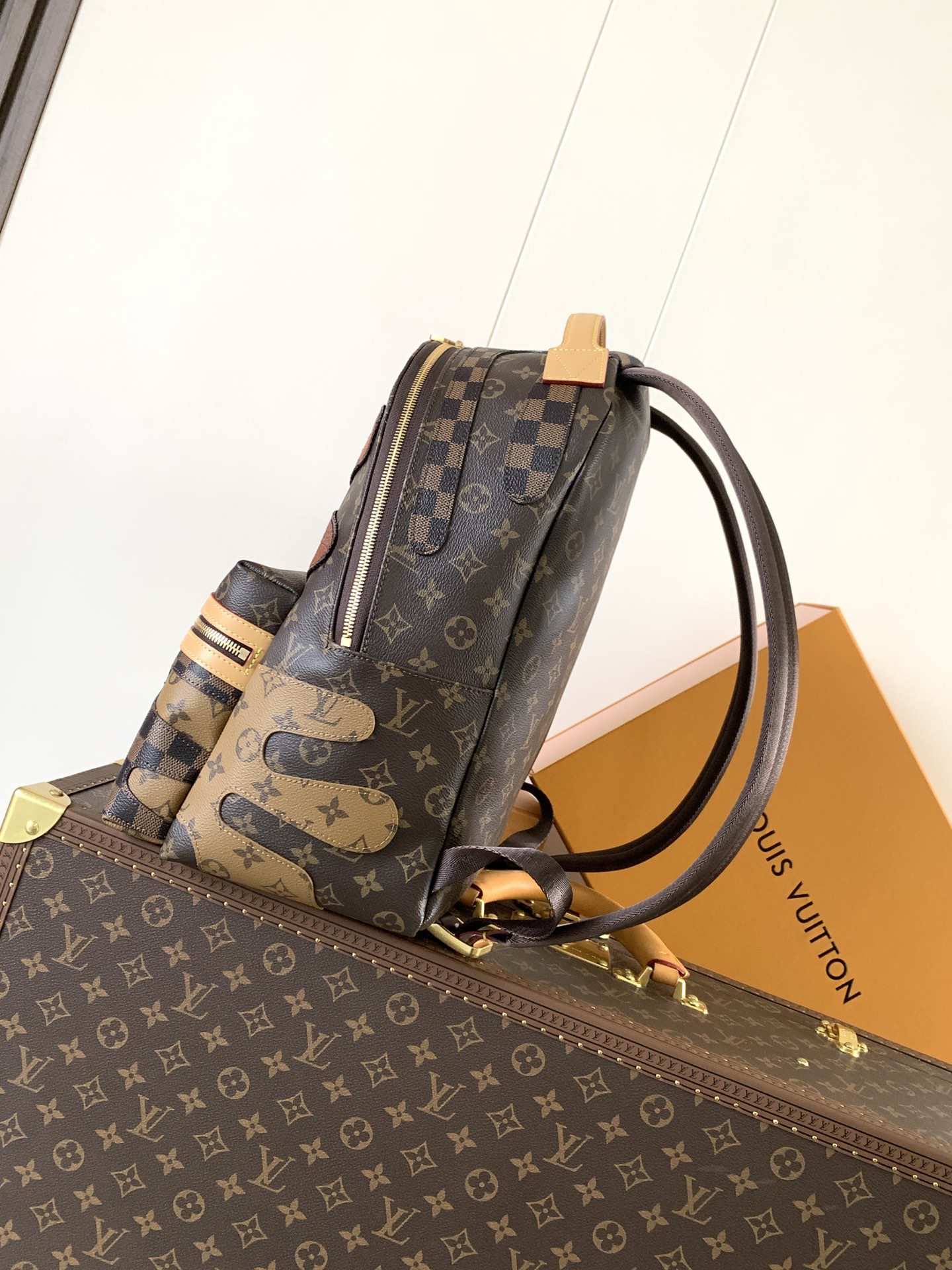 1 Louis Vuitton This Discovery Small Backpack features Monogram canvas accented with Monogram Reverse and Damier canvas patches.