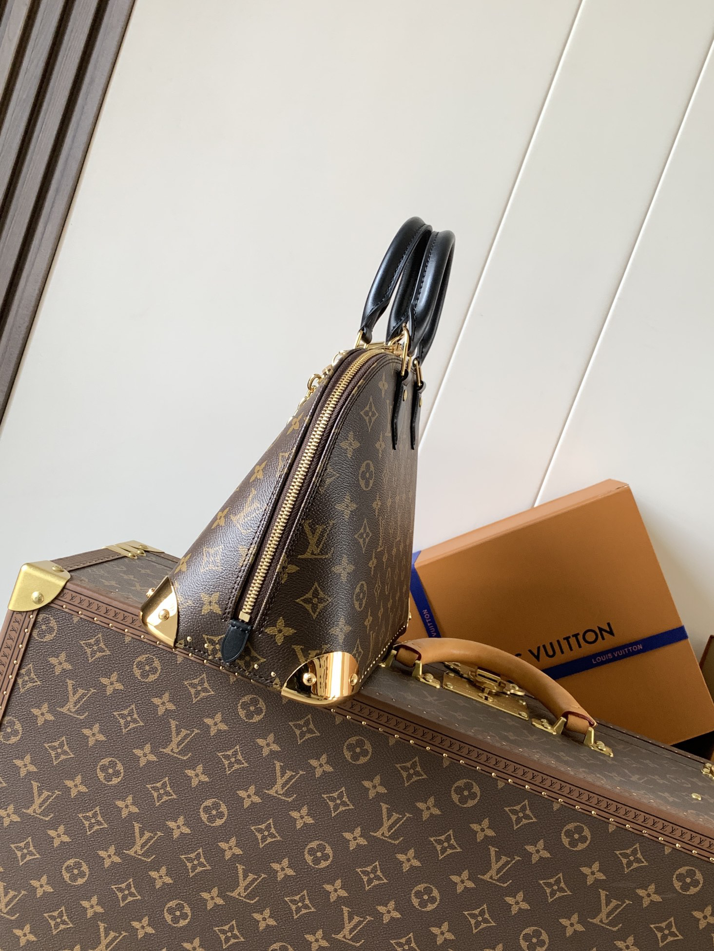 1 Louis Vuitton The Trunk collection welcomes a contemporary new iteration of the Alma Small handbag, paying homage to the brand's travel heritage with exquisite metal hardware.