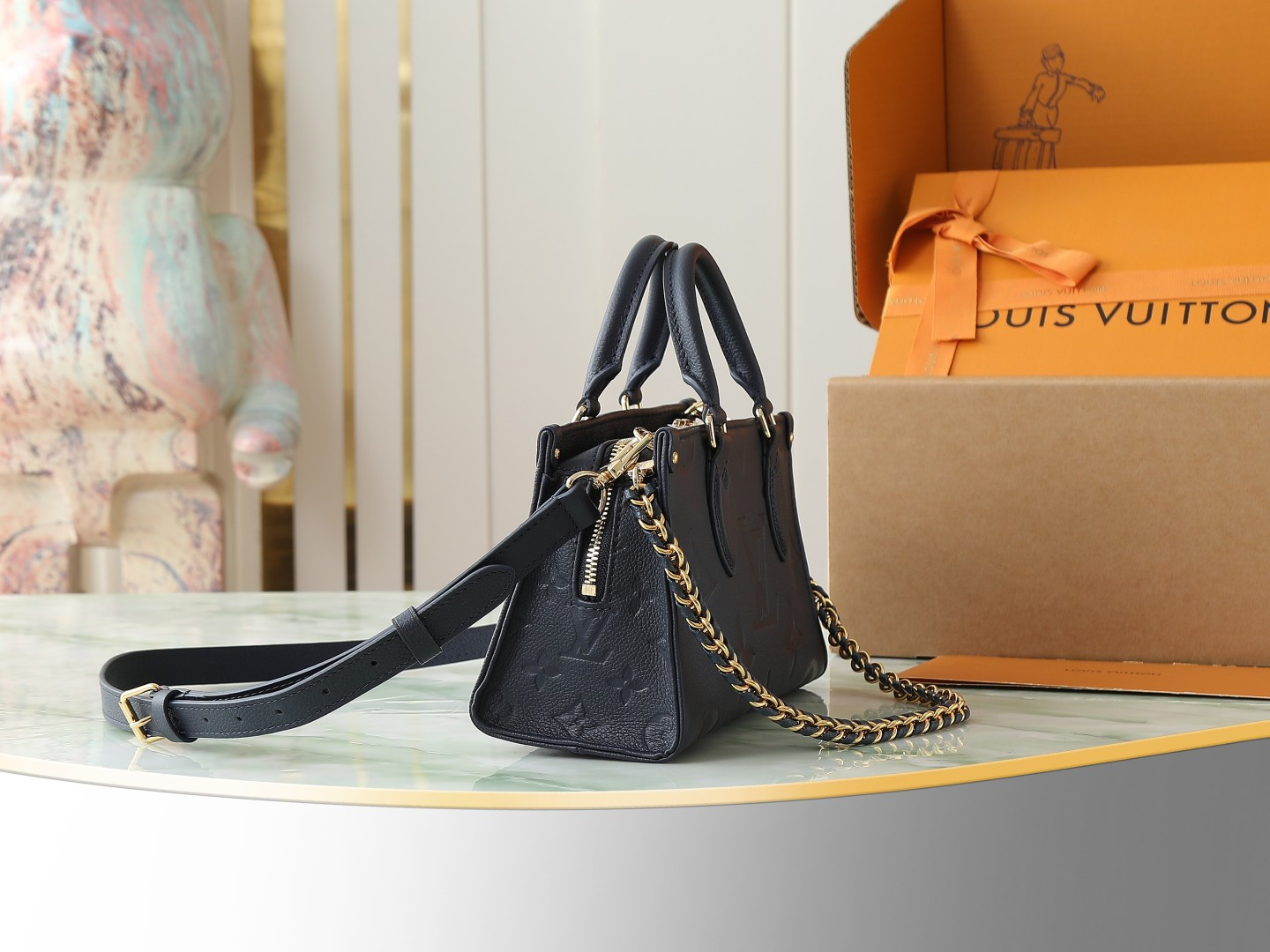 1 Louis Vuitton M23640 Deep Blue Embossed: This small OnTheGo handbag is crafted from Monogram Empreinte leather, embossed with the Giant Monogram pattern.