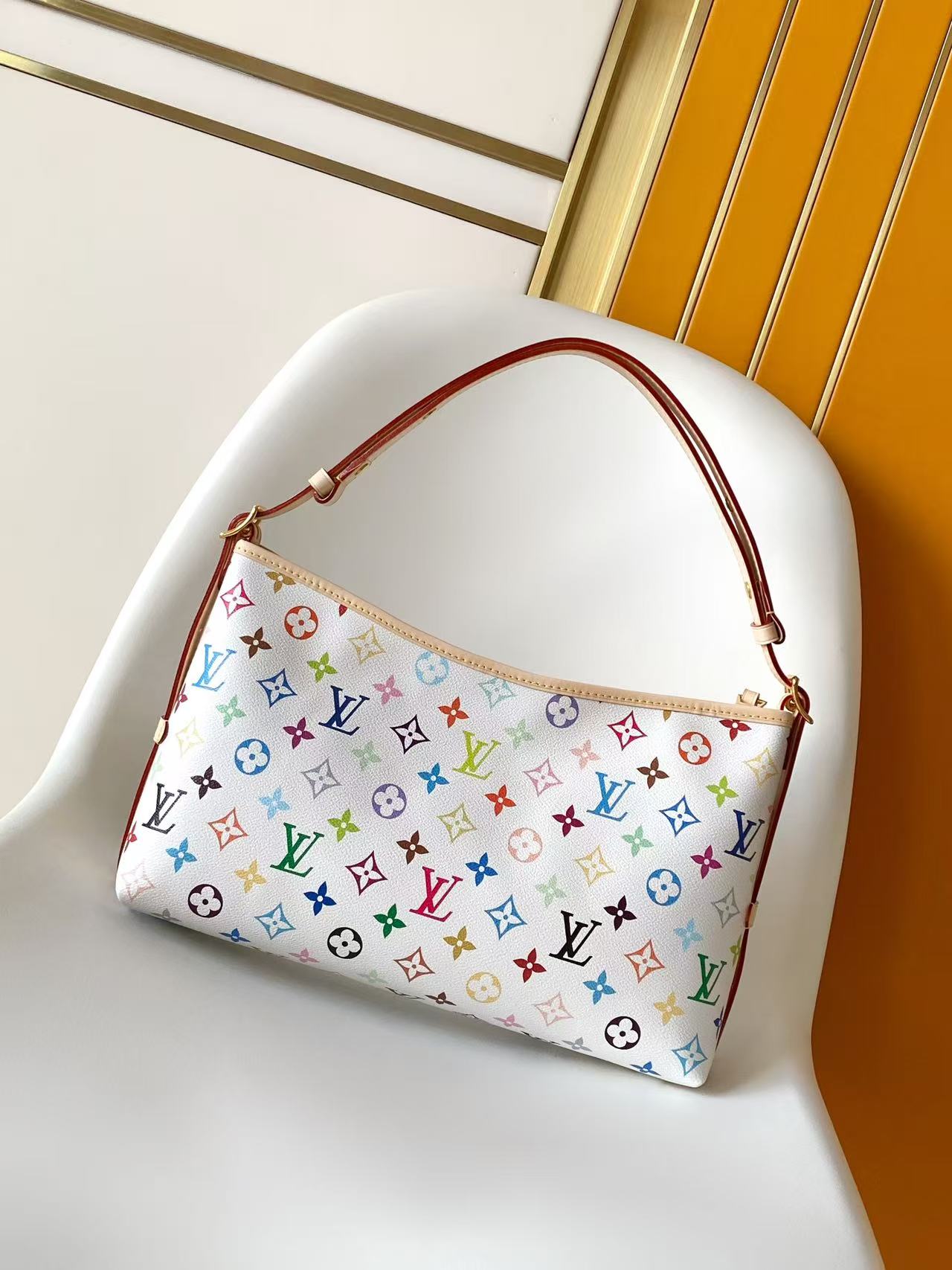 2 Louis Vuitton This Carryall East-West canvas handbag illuminates this classic element with a vibrant splash of color.