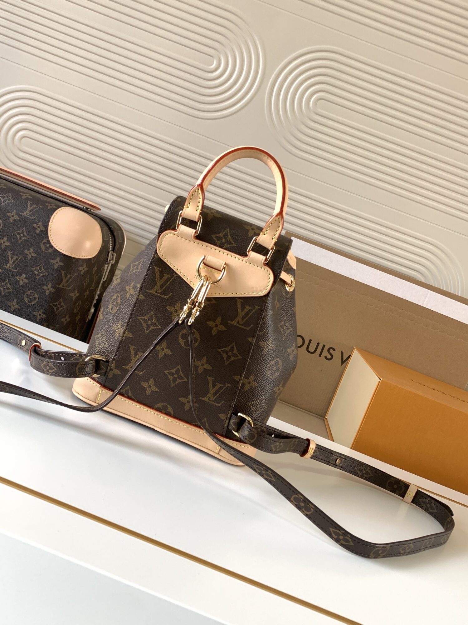 2 Louis Vuitton This Montsouris Mini features Monogram coated canvas with cowhide leather trim.