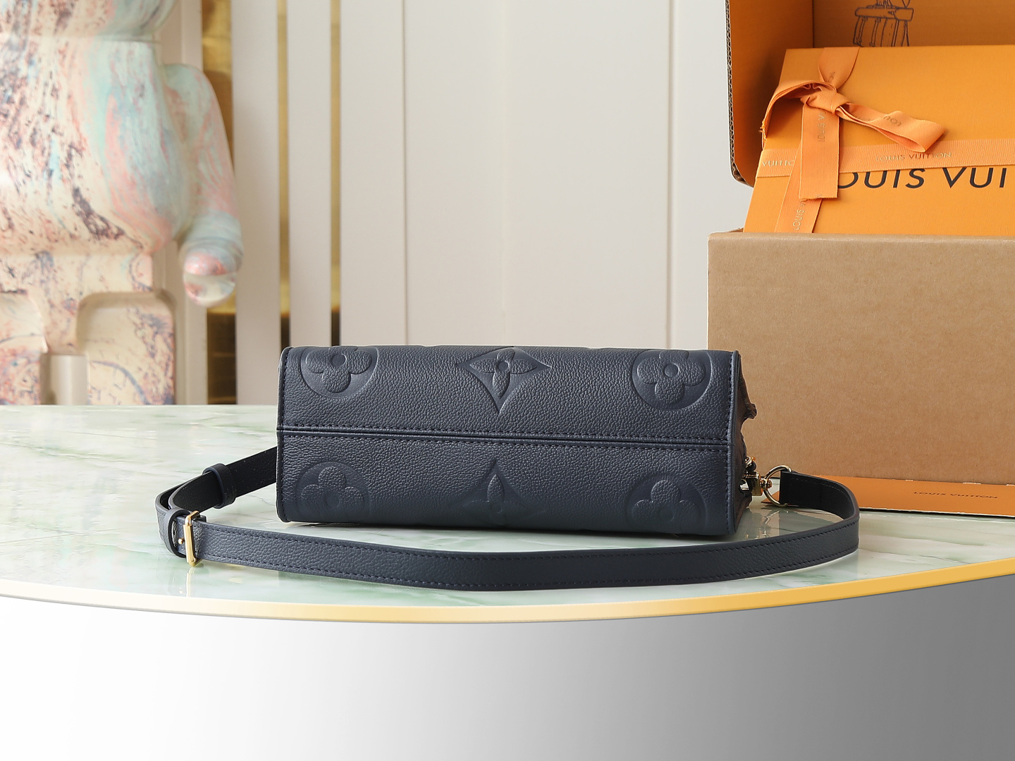 3 Louis Vuitton M23640 Deep Blue Embossed: This small OnTheGo handbag is crafted from Monogram Empreinte leather, embossed with the Giant Monogram pattern.