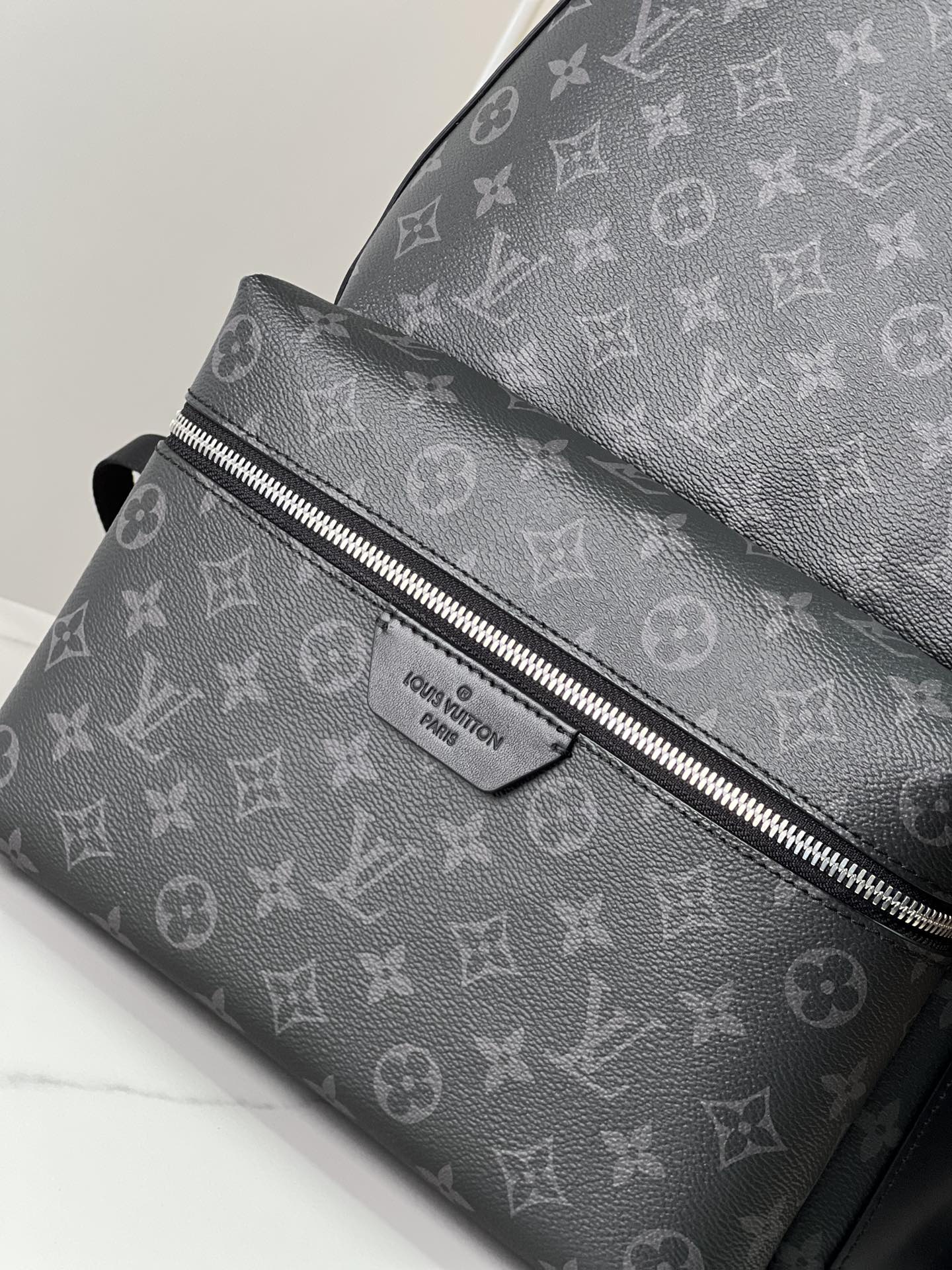 4 Crafted from Monogram Eclipse canvas, this small Discovery backpack retains its versatile functionality in a more compact silhouette.