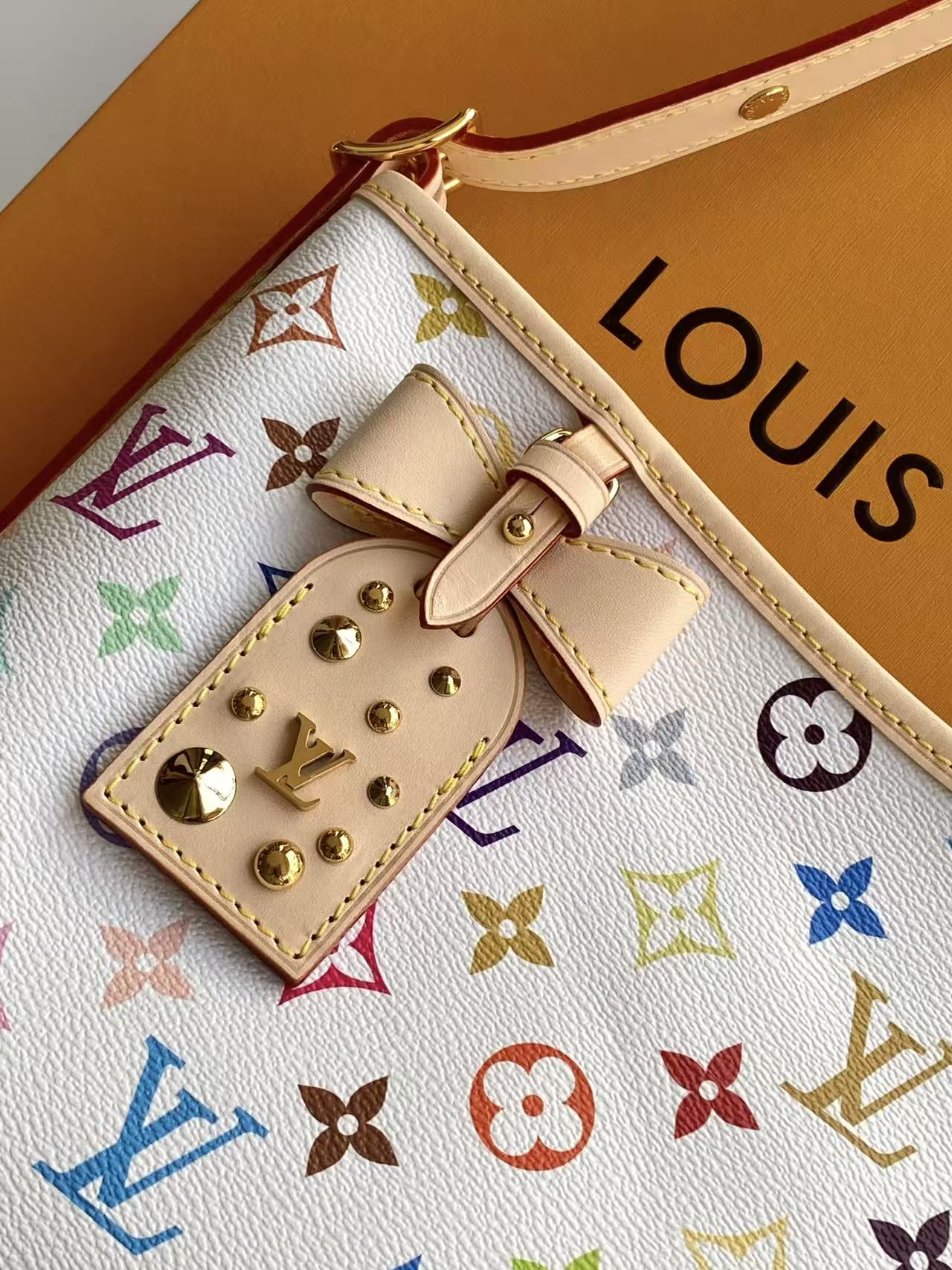 4 Louis Vuitton This Carryall East-West canvas handbag illuminates this classic element with a vibrant splash of color.