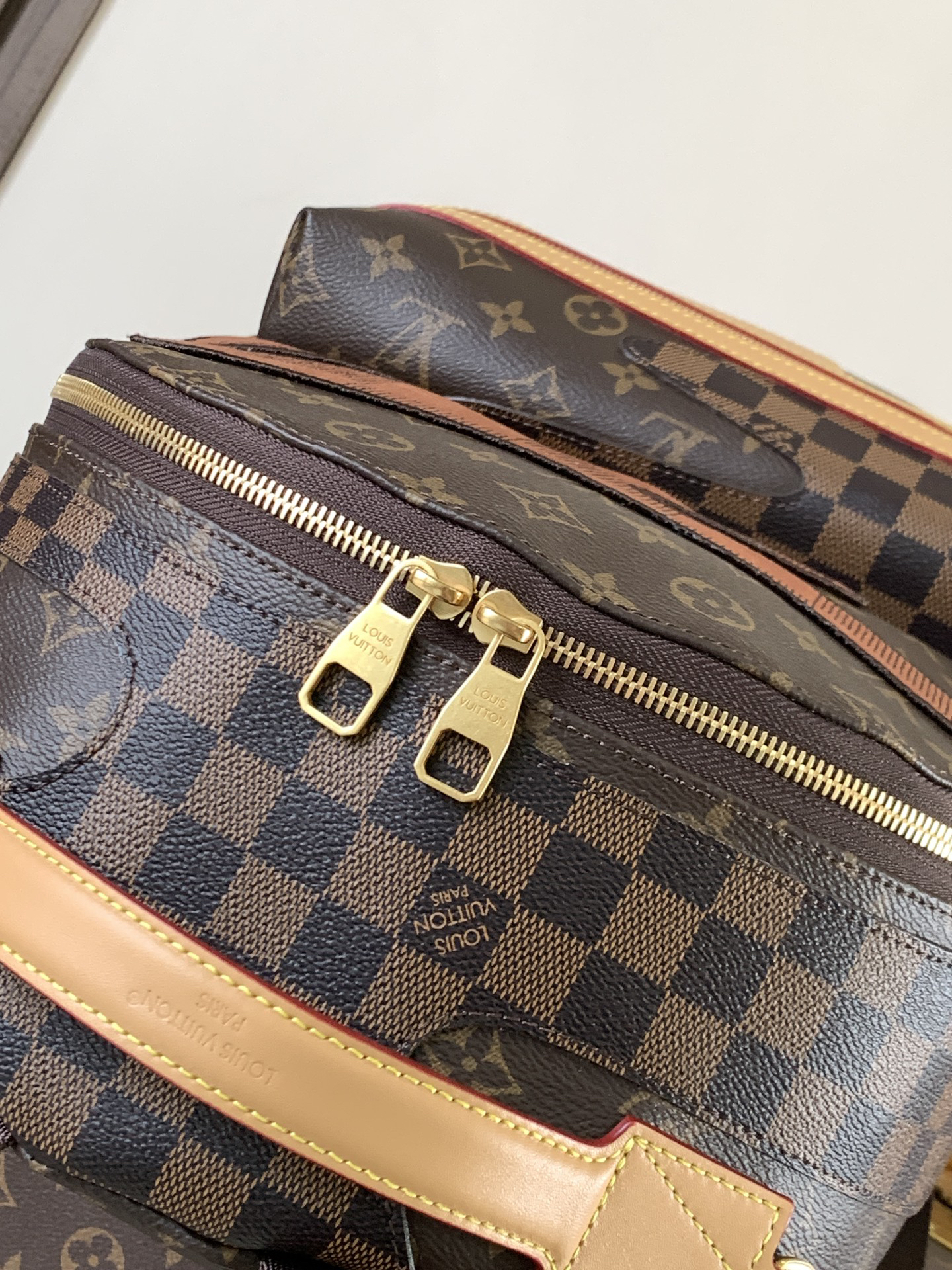4 Louis Vuitton This Discovery Small Backpack features Monogram canvas accented with Monogram Reverse and Damier canvas patches.