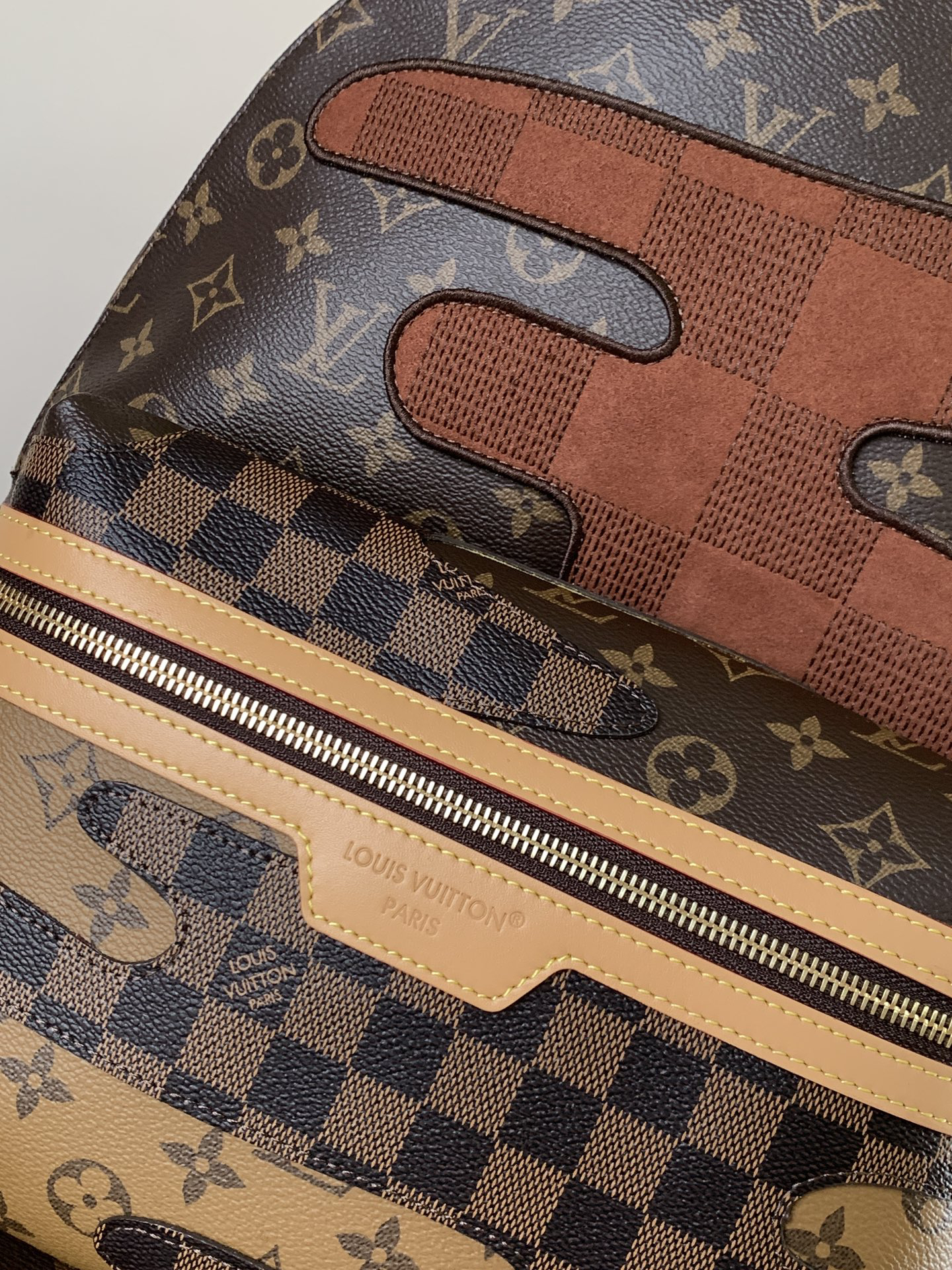 5 Louis Vuitton This Discovery Small Backpack features Monogram canvas accented with Monogram Reverse and Damier canvas patches.