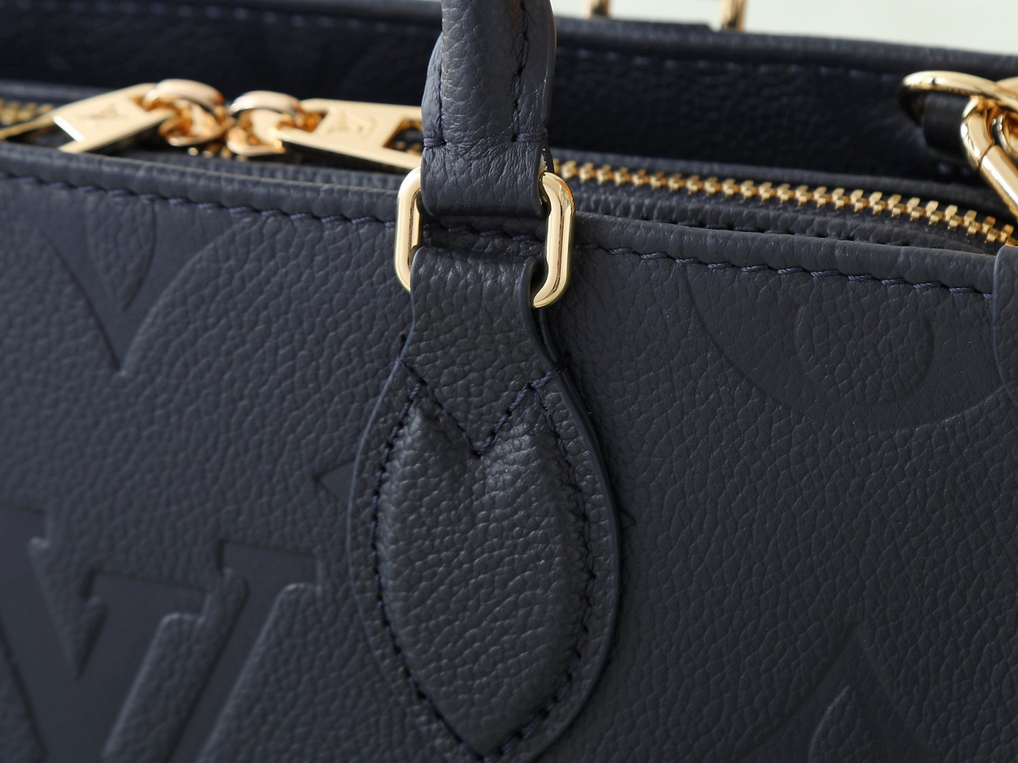 5 Louis Vuitton M23640 Deep Blue Embossed: This small OnTheGo handbag is crafted from Monogram Empreinte leather, embossed with the Giant Monogram pattern.