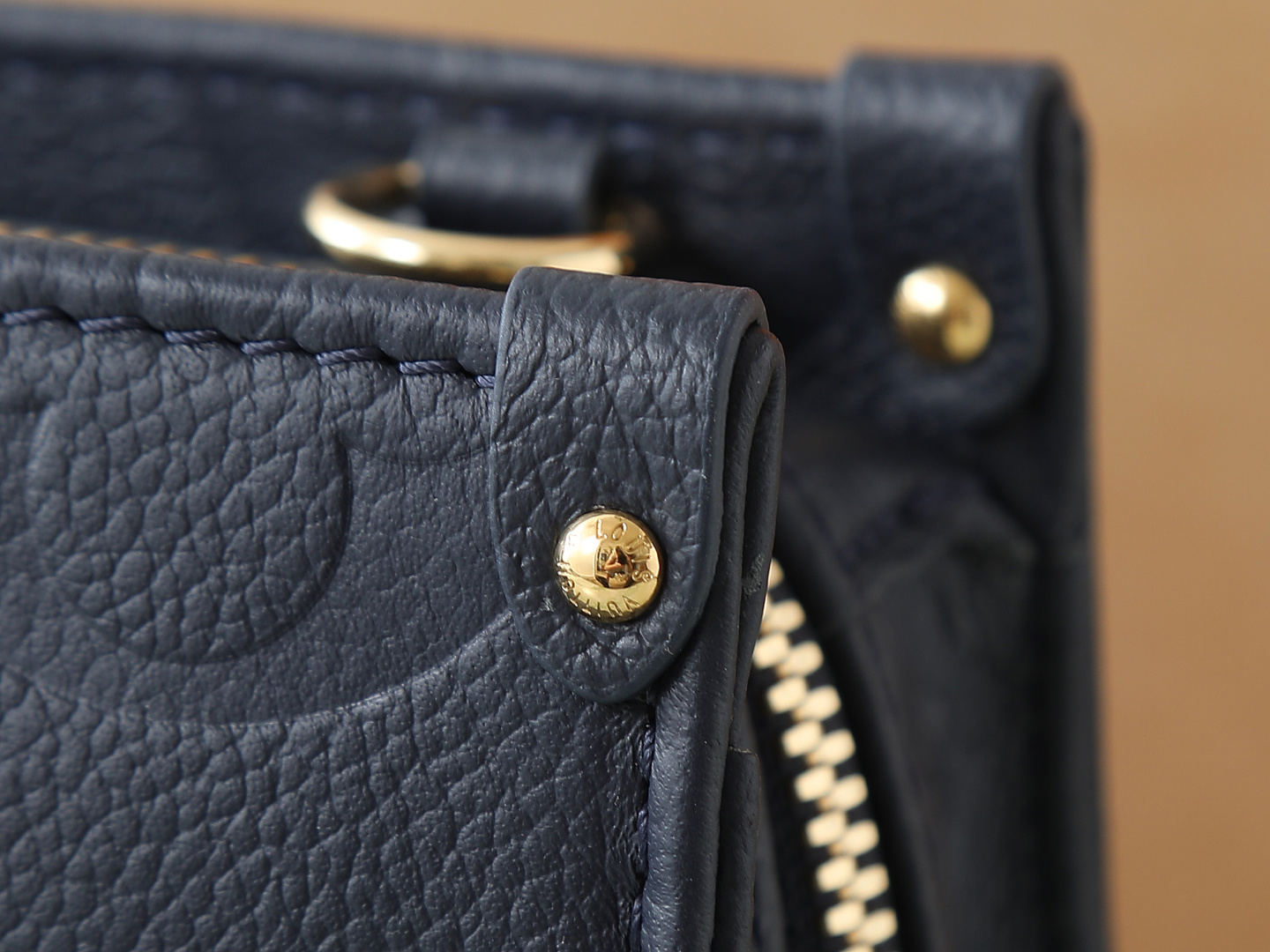 6 Louis Vuitton M23640 Deep Blue Embossed: This small OnTheGo handbag is crafted from Monogram Empreinte leather, embossed with the Giant Monogram pattern.