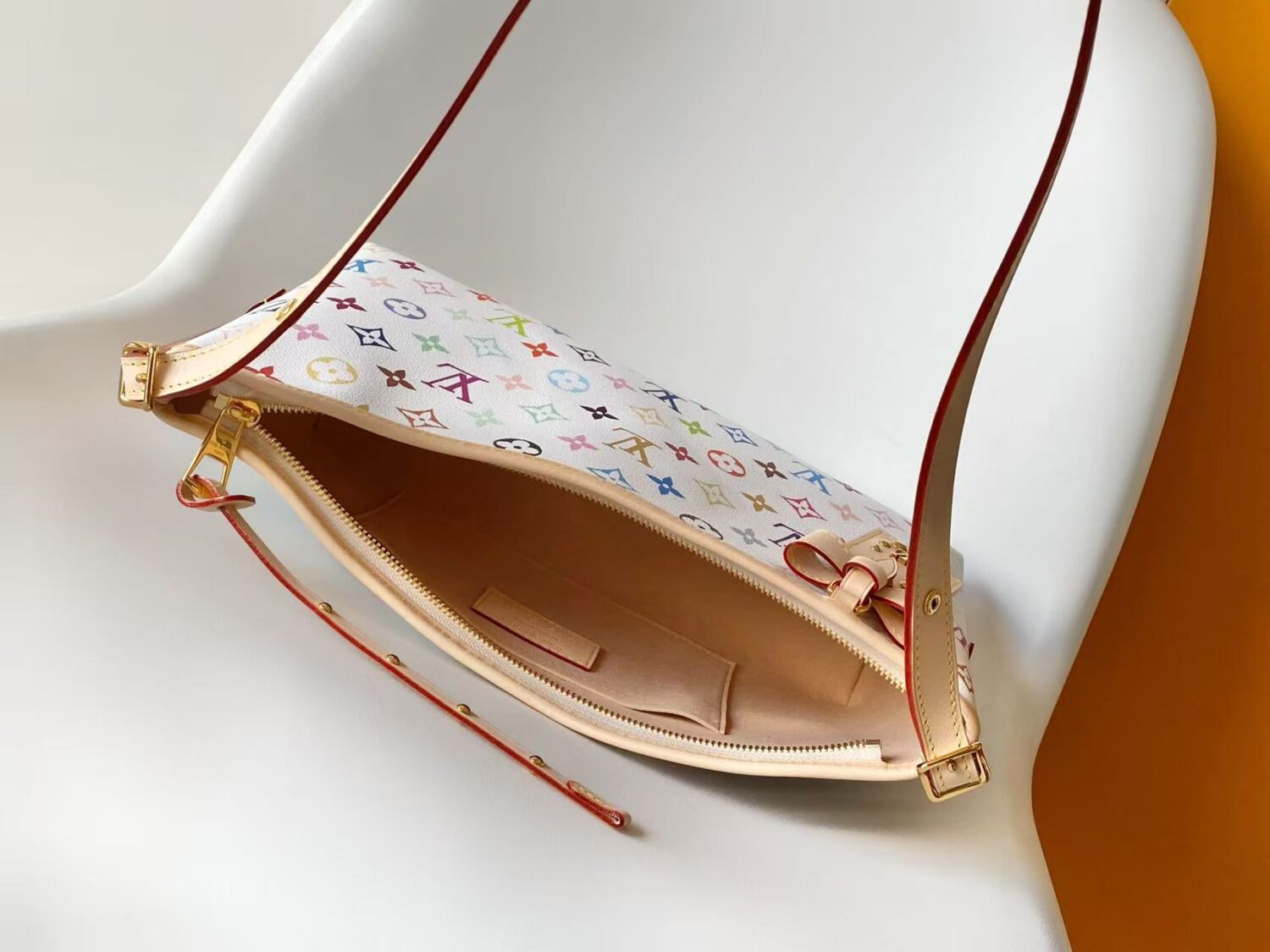 7 Louis Vuitton This Carryall East-West canvas handbag illuminates this classic element with a vibrant splash of color.