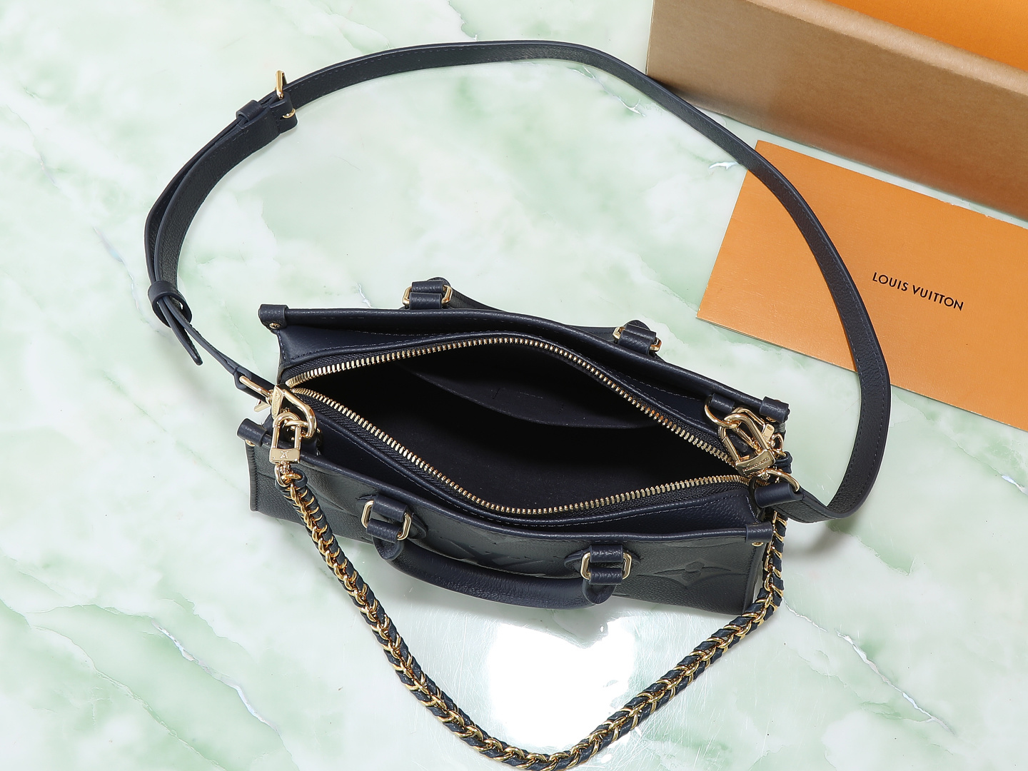 7 Louis Vuitton M23640 Deep Blue Embossed: This small OnTheGo handbag is crafted from Monogram Empreinte leather, embossed with the Giant Monogram pattern.