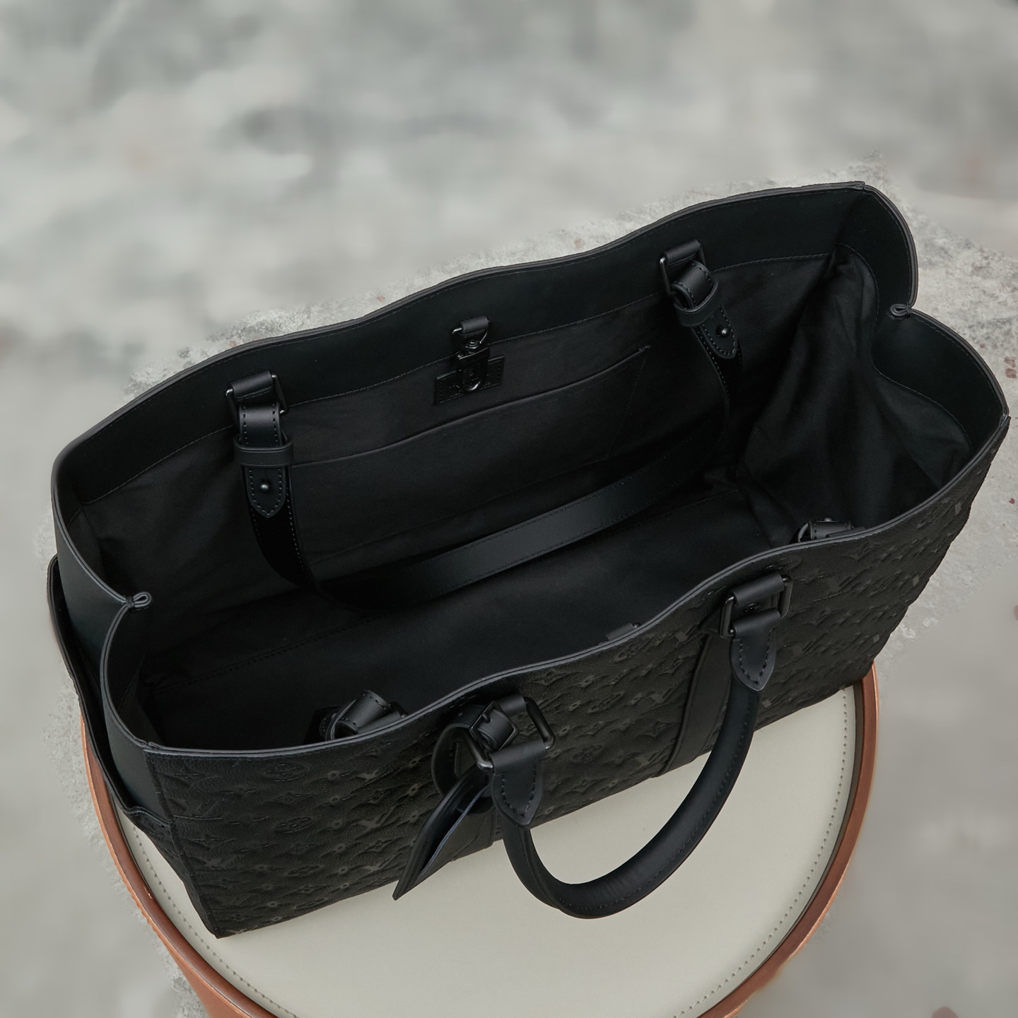 8 Louis Vuitton This Sac Plat 24H bag is crafted from Monogram-embossed Taurillon leather.