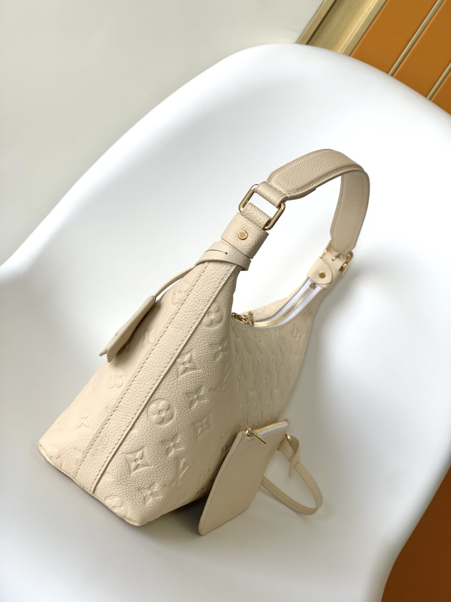 1 Louis Vuitton The Sac Sport handbag features a curved silhouette crafted from supple Monogram Empreinte embossed leather.