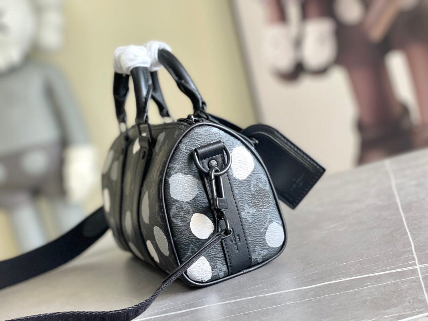 1 Louis Vuitton M46406 Black Floral Polka Dot Yayoi Kusama Handbag: This handbag encapsulates the classic silhouette of a travel bag and is crafted from embossed leather.