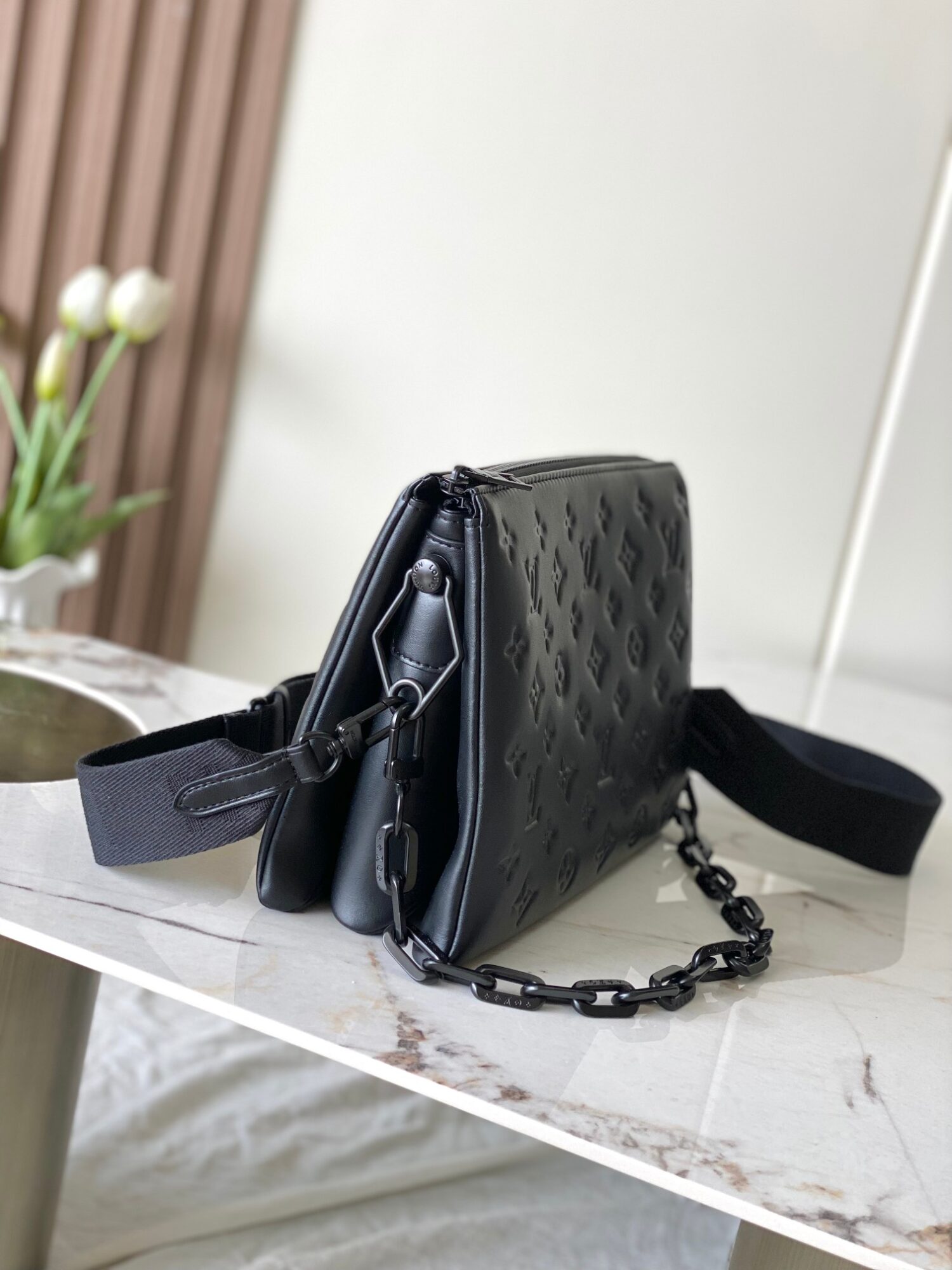 1 Louis Vuitton M11370 Black embossed leather bag with black chain.
