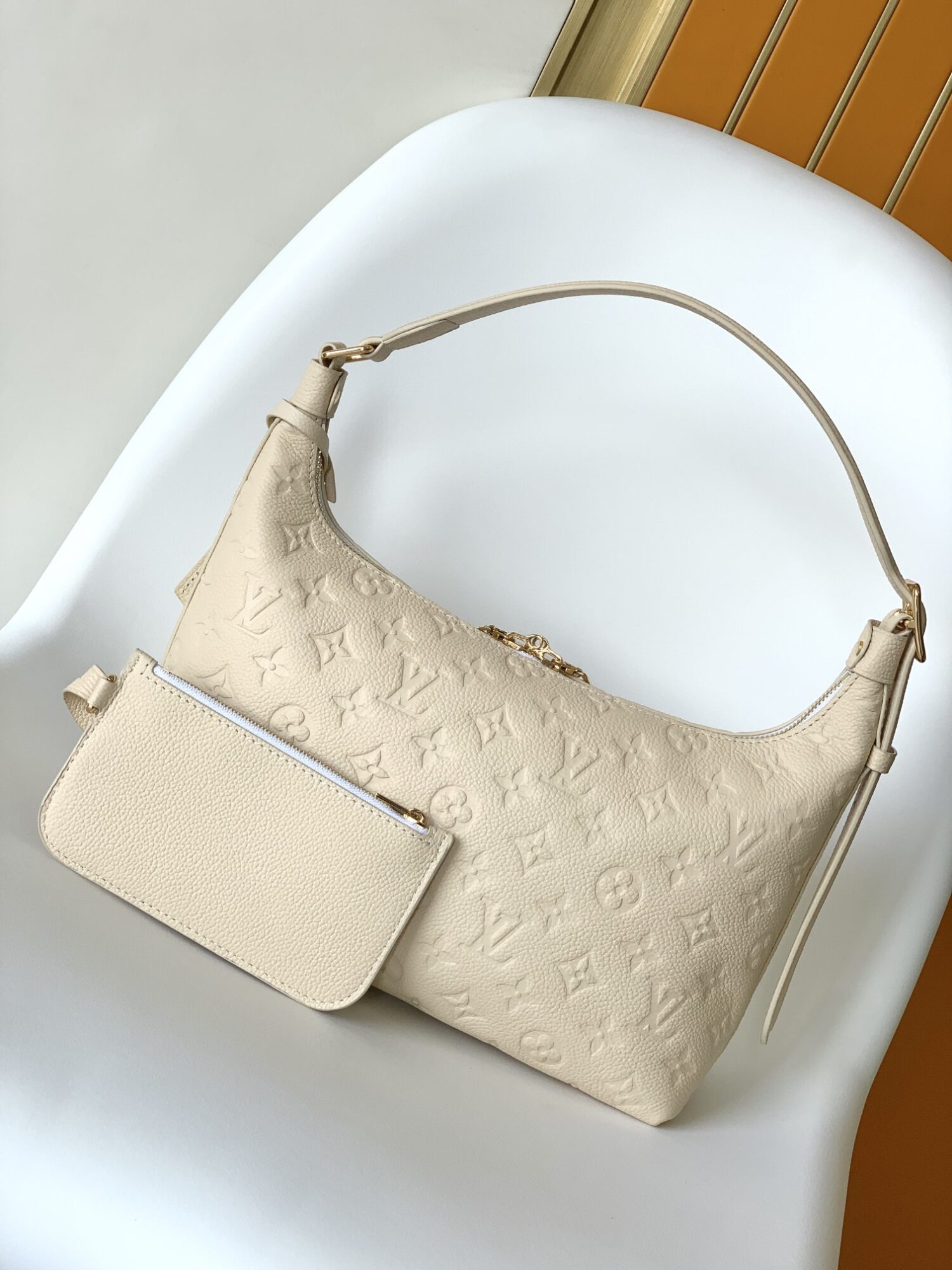 2 Louis Vuitton The Sac Sport handbag features a curved silhouette crafted from supple Monogram Empreinte embossed leather.