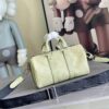 2 Louis Vuitton M14078 Light Khaki Green Pillow Bag. This Keepall 25 handbag is made of Monogram Eclipse Reverse canvas.