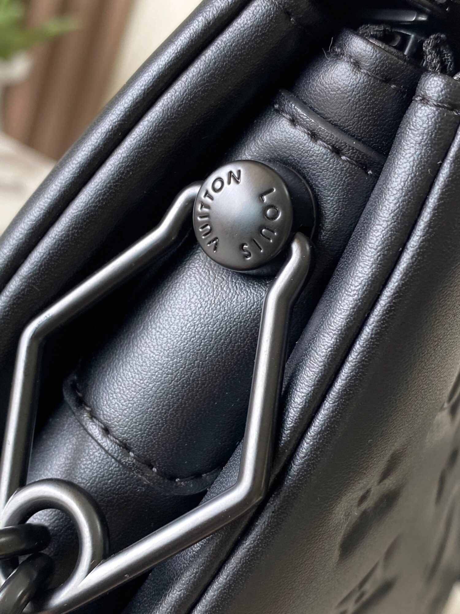4 Louis Vuitton M11370 Black embossed leather bag with black chain.
