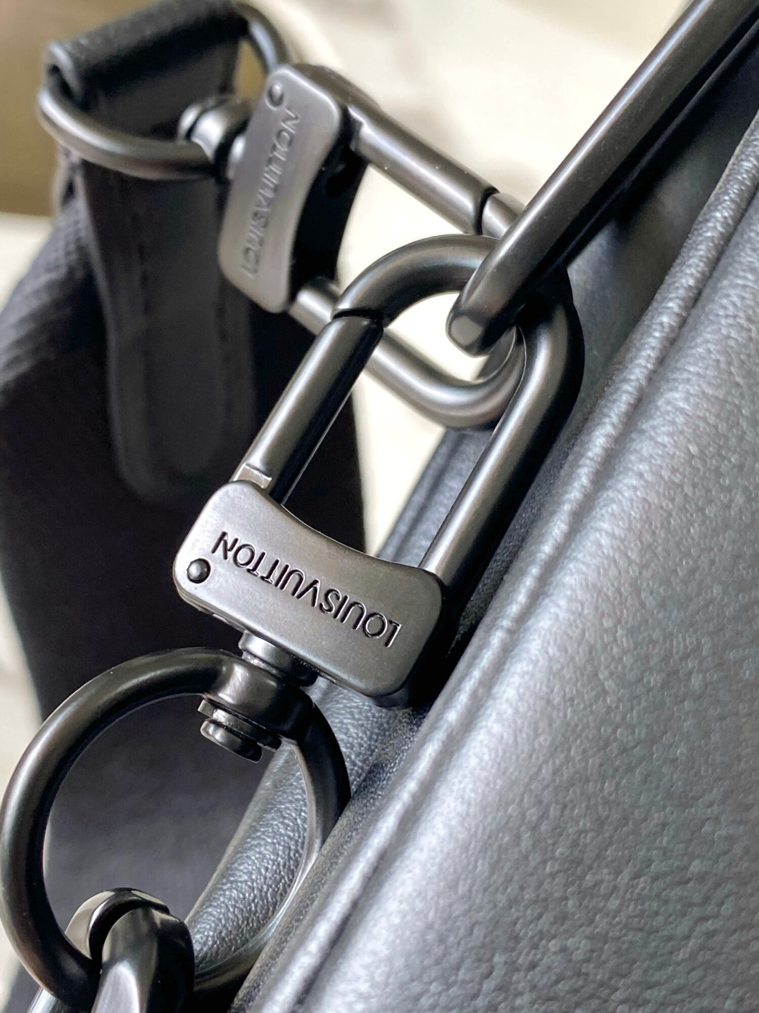 5 Louis Vuitton M11370 Black embossed leather bag with black chain.