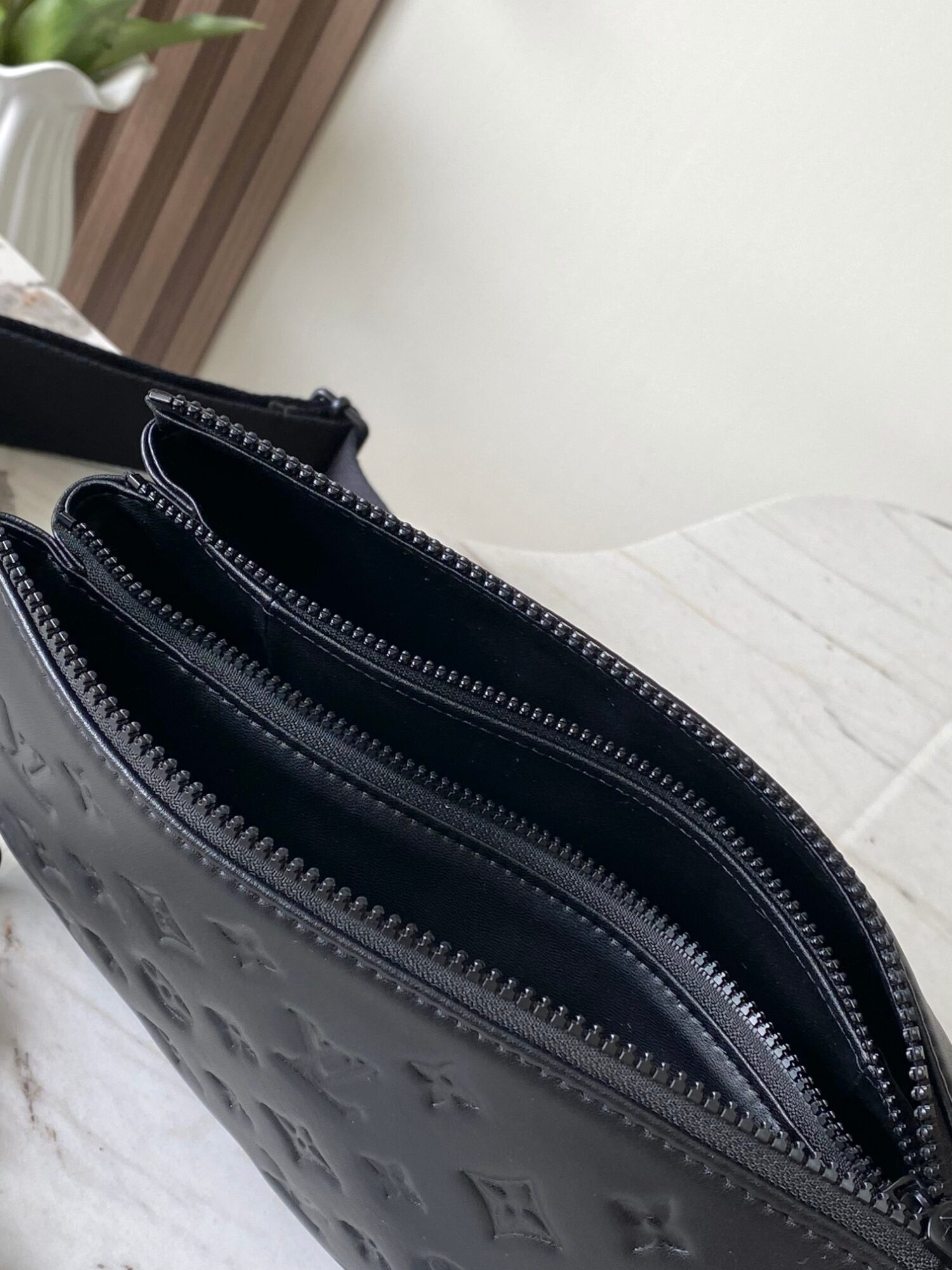 7 Louis Vuitton M11370 Black embossed leather bag with black chain.