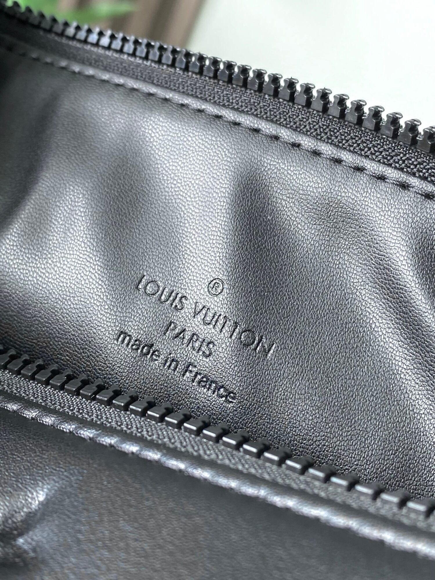 8 Louis Vuitton M11370 Black embossed leather bag with black chain.